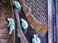 Bronze figurines on the door to San Pietro