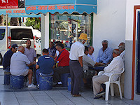 Like one would see in any Spanish village, locals gather in the town square to play cards and dominoes.