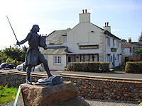 Statue of Edward I in front of the Greyhound Inn