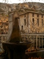 A fountain in Fontaine with an old paper mill and a 15th century castle built by the Bishops of Cavaillon