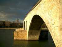 The setting sun illuminates the pont.