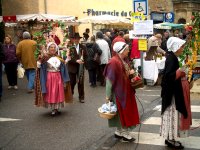 Men and women wearing traditional Provençal dress in the procession for the truffle mass.